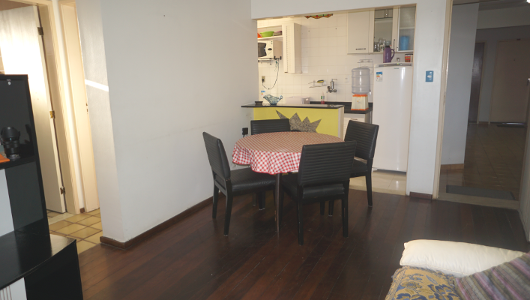 dining table with part of the kitchen